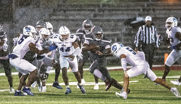 Virginia Union running back Curtis Allen runs the ball in the rainstorm Saturday against challengers from Fayetteville State.