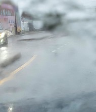 Tropical Storm Ophelia’s heavy rains, flooding and strong winds sweep through the city Sept. 23. A motorist navigates pouring rain along Meadow Street and Overbrook Road in Richmond.