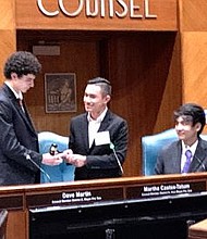 Alexavier Mendoza (center), MYC 2022-2023 chair,
passes the gavel to new chair Michael Hamad.