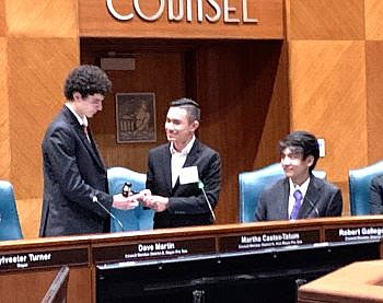 Alexavier Mendoza (center), MYC 2022-2023 chair,
passes the gavel to new chair Michael Hamad.