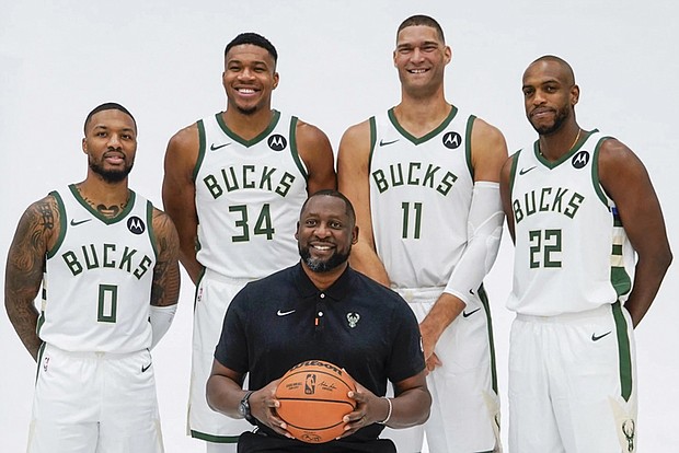 Miwaukee Bucks players Damian Lillard, Giannis Antetokounmpo, Brook Lopez, Khris Middleton and Coach Adrian Griffin pose for a photo during the NBA basketball team’s media day earlier this week.