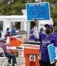 Richmonders will vote for or against the casino project in a Nov. 7 referendum. The Richmond Grand Resort and Casino is a $562 million proposal by Black-owned multimedia conglomerate Urban One and new partner Churchill Downs. Right, a volunteer holds up a “Vote Yes for Richmond Grand Resort and Casino” sign during the event.