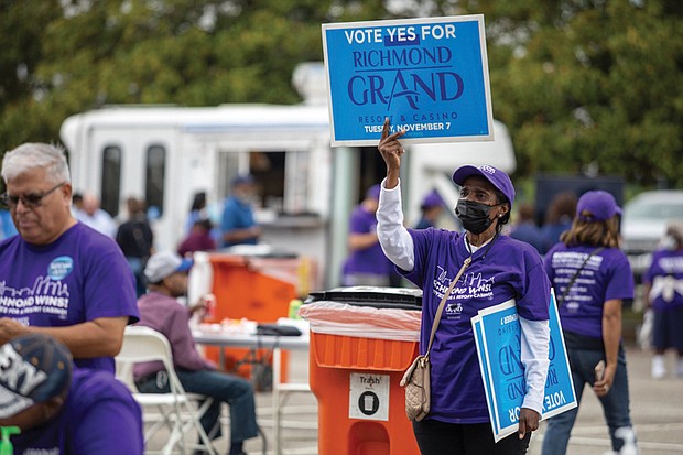 Richmonders will vote for or against the casino project in a Nov. 7 referendum. The Richmond Grand Resort and Casino is a $562 million proposal by Black-owned multimedia conglomerate Urban One and new partner Churchill Downs. Right, a volunteer holds up a “Vote Yes for Richmond Grand Resort and Casino” sign during the event.
