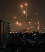 The Iron Dome defense missile system attempts to intercept rockets fired from the Gaza Strip over the city of Netivot in southern Israel on October 8.
Mandatory Credit:	Mahmud Hams/AFP via Getty Images