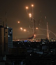 The Iron Dome defense missile system attempts to intercept rockets fired from the Gaza Strip over the city of Netivot in southern Israel on October 8.
Mandatory Credit:	Mahmud Hams/AFP via Getty Images