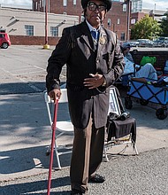 Phillip Brown Sr., dressed to the nines, makes his annual pilgrimage greeting friends, old and new.