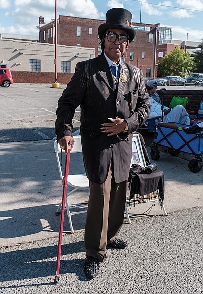 Phillip Brown Sr., dressed to the nines, makes his annual pilgrimage greeting friends, old and new.