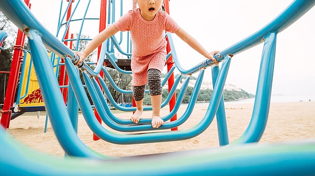 Playgrounds can help children develop physical and social skills so parents and guardians should be prepared when their kids try out new equipment at the park.
Mandatory Credit:	Tang Ming Tung/Stone RF/Getty Images