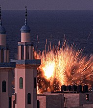 A fireball erupts from an Israeli airstrike in Gaza City on October 12, 2023.
Mandatory Credit:	Mahmud Hams/AFP/Getty Images