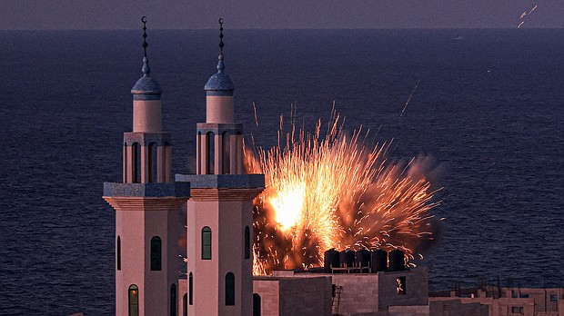 A fireball erupts from an Israeli airstrike in Gaza City on October 12, 2023.
Mandatory Credit:	Mahmud Hams/AFP/Getty Images