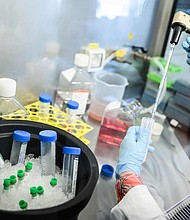 A woman works on a lung cancer vaccine on October 1 at the Ose Immunotherapeutics laboratory in Nantes.
Mandatory Credit:	Loic Venance/AFP/Getty Images