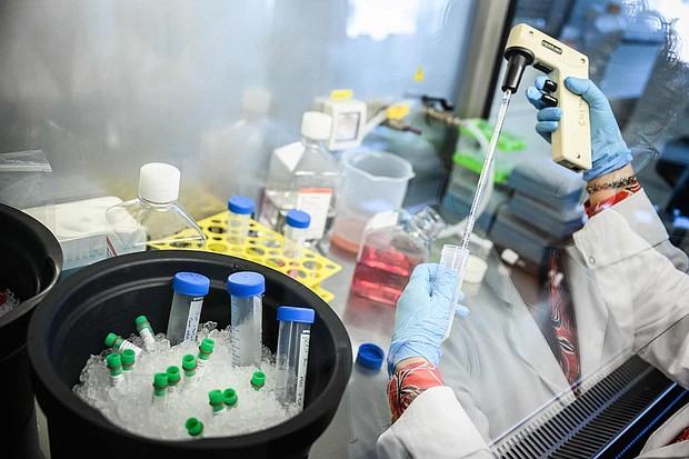 A woman works on a lung cancer vaccine on October 1 at the Ose Immunotherapeutics laboratory in Nantes.
Mandatory Credit:	Loic Venance/AFP/Getty Images