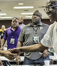 Legendary VSU and Richmond Public Schools Football Coach Lou Anderson left, is congratulated for his Lifetime Achievement honors by another coaching legend and friend Willard Bailey at a VUU Football Coaches Clinic in the Henderson Center on the school’s campus.