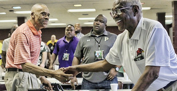 Legendary VSU and Richmond Public Schools Football Coach Lou Anderson left, is congratulated for his Lifetime Achievement honors by another coaching legend and friend Willard Bailey at a VUU Football Coaches Clinic in the Henderson Center on the school’s campus.