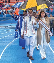 Mr. Virginia State University, Christopher Lawrence, and Miss Virginia State University, Aliya Mayers, wave to the crowd during the game, which drew 3,409 people. VSU won 39-23 over Bluefield State, leaving the Trojans 7-0 overall and atop the CIAA North with a 5-0 record.