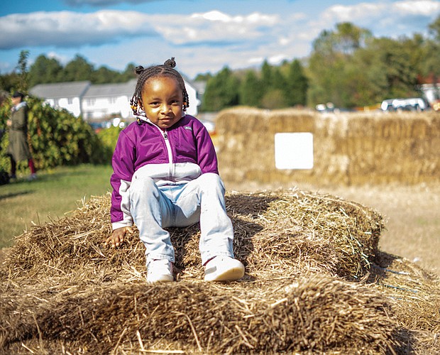 Zuri Grant, 4, tackles a giant haystack while visiting Gallmeyer Farms on Millers Lane in Henrico County with her mother, Briana Brockington, on Oct. 21.