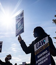 A "UAW On Strike" sign held on a picket line outside the Stellantis Sterling Heights Assembly Plant in Sterling Heights, Michigan, on Oct. 23.
Mandatory Credit:	Emily Elconin/Bloomberg/Getty Images