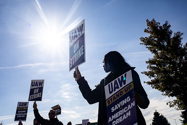 A "UAW On Strike" sign held on a picket line outside the Stellantis Sterling Heights Assembly Plant in Sterling Heights, Michigan, on Oct. 23.
Mandatory Credit:	Emily Elconin/Bloomberg/Getty Images