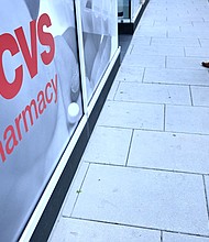 In this November 2022 photo, a pedestrian walks into a CVS Pharmacy in Washington, DC.
Mandatory Credit:	Brendan Smialowski/AFP/Getty Imagesh