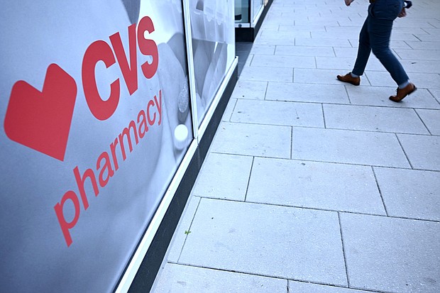 In this November 2022 photo, a pedestrian walks into a CVS Pharmacy in Washington, DC.
Mandatory Credit:	Brendan Smialowski/AFP/Getty Imagesh