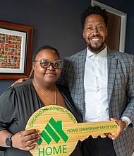 Samantha Stokes, the first Chicago Housing Authority resident to close on a home in the CHA’s new Down Payment Assistance (DPA) program, stands with DPA Program Manager Jimmy Stewart at her closing in early October.