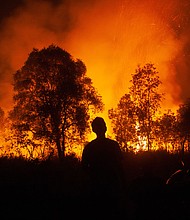 A forest fire approaches homes in Ogan Ilir, South Sumatra, in October 2023.
Mandatory Credit:	Al Zulkifli/AFP via Getty Image