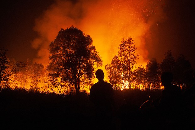 A forest fire approaches homes in Ogan Ilir, South Sumatra, in October 2023.
Mandatory Credit:	Al Zulkifli/AFP via Getty Image