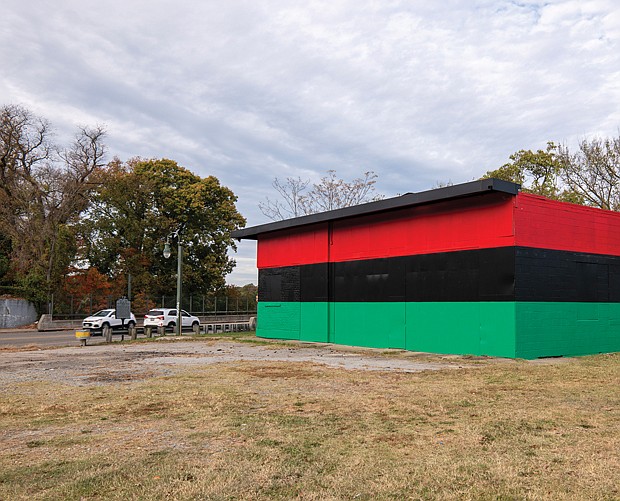 Phillips J. Mckenzie and James C. Weeks of LK Vass painting company are repainting an old service station in vibrant shades of red, black and green. The building stands at the Historic Shockoe Hill African Burying Ground, 1305 N. 5th St. Giant letters noting that 22,00 people were buried in the once forgotten cemetery will be added to the rear of building that faces Interstate 64.