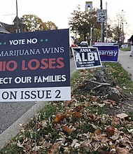A sign against Issue 2 to legalize recreational marijuana use sits near a polling place on Election Day in Cincinnati.