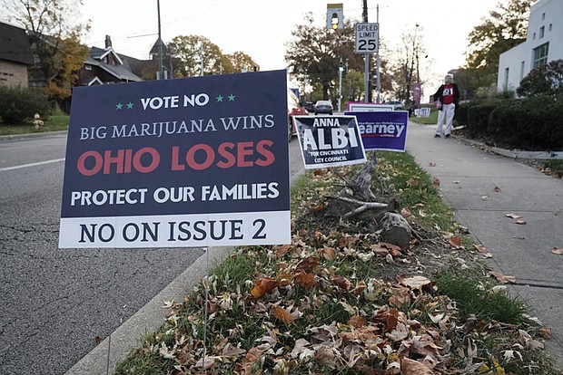A sign against Issue 2 to legalize recreational marijuana use sits near a polling place on Election Day in Cincinnati.