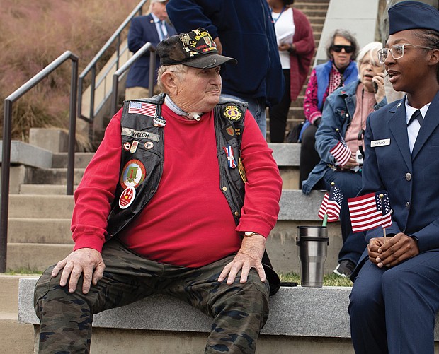 Airman Basic Ke’Mya Whitlock, right, chats with U.S. Army Vietnam War veteran Jerry Welch before the Veterans Day Ceremony. Members of the U.S. Marine Corps stationed at Ft. Gregg-Adams, home of the Combined Arms Support Command, participate in the Veterans Day Ceremony.