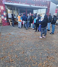 People line up as early as 8 a.m. on Saturday, Nov. 18, to receive numbers that allow them to shop at the Meadowbridge Community Market when it opens at 10 a.m. The market, which provides free grocery items, is at 3613 Meadowbridge Road.