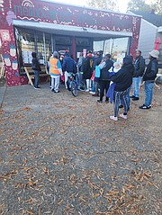 People line up as early as 8 a.m. on Saturday, Nov. 18, to receive numbers that allow them to shop at the Meadowbridge Community Market when it opens at 10 a.m. The market, which provides free grocery items, is at 3613 Meadowbridge Road.