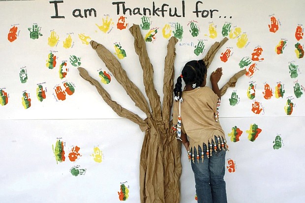 A student places her handprint along with those of other students at a primary school in Lufkin, Texas.