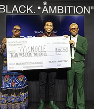 Richmond native Leslie Winston III and his company, Monocle, was the HBCU Grand Prize Winner at the 3rd Annual Black Ambition Demo Day on Nov. 9 in New York.
He accepts his prize from entrepreneur, musician and philanthropist Pharrell Williams, whose Black Ambition nonprofit initiative was founded in 2020, and Felecia Hatcher, CEO of Black Ambition.