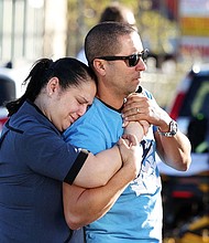 Parents Mabel Fontanilla and Raul Villalonga embrace after a shooting at the University of Nevada, Las Vegas, campus on Wednesday.
Mandatory Credit:	Ronda Churchill/AFP/Getty Images