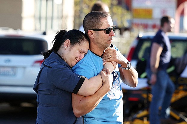 Parents Mabel Fontanilla and Raul Villalonga embrace after a shooting at the University of Nevada, Las Vegas, campus on Wednesday.
Mandatory Credit:	Ronda Churchill/AFP/Getty Images