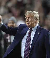Former Republican President Donald Trump waves to the crowd Nov. 25 during halftime at an NCAA college football game between the University of South Carolina and Clemson in Columbia, S.C.