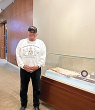 Chief Wait “Red Hawk” Brown, president and CEO of Cheroenhaka Nottoway Enterprises in Courtland, stands near an exhibition showcase during a Dec. 4 “Indigenous Perspectives’” media preview at the Library of Virginia.