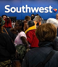 Travelers wait in line at the Southwest Airlines ticketing counter at Nashville International Airport after the airline canceled thousands of flights in Nashville, Tennessee on December 27, 2022.
Mandatory Credit:	Seth Herald/AFP/Getty Images