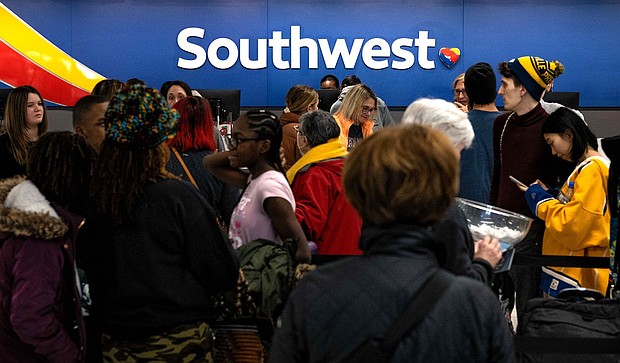 Travelers wait in line at the Southwest Airlines ticketing counter at Nashville International Airport after the airline canceled thousands of flights in Nashville, Tennessee on December 27, 2022.
Mandatory Credit:	Seth Herald/AFP/Getty Images