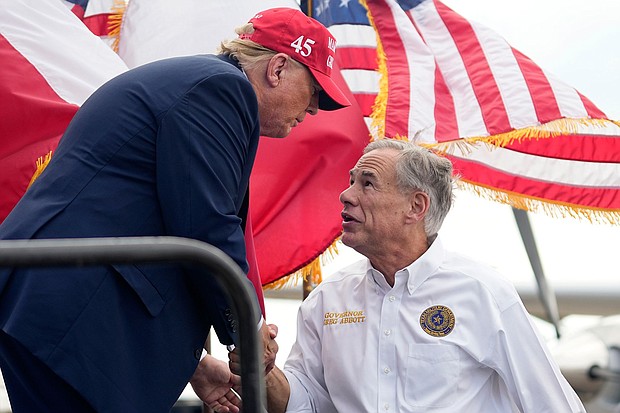 Former President Donald Trump shakes hands with Texas Gov. Greg Abbott at an event in Edinburg, Texas, on November 19.
Mandatory Credit:	Eric Gay/AP