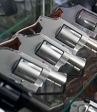 A sales associate arranges a display of guns at a firearms store in Burbank, California.
Mandatory Credit:	Jae C. Hong/AP/FILE