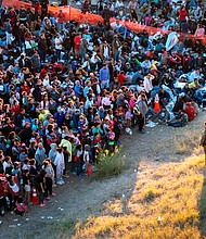 In an aerial view, a U.S. Border Patrol agent watches over migrants waiting to be processed after crossing from Mexico into the United States on December 17 in Eagle Pass, Texas.
Mandatory Credit:	John Moore/Getty Images