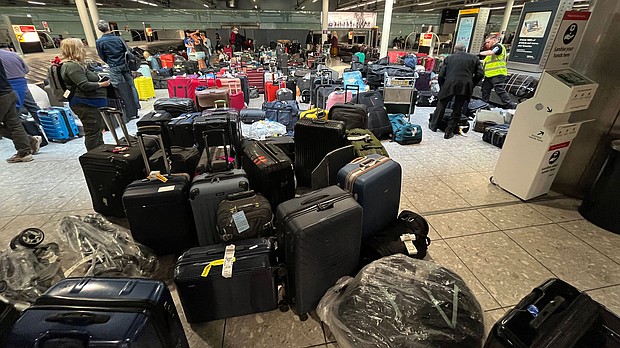 Uncollected suitcases are gathered at Heathrow Airport's Terminal 3 baggage reclaim on July 8, and such scenes have people wondering how to avoid such a mess.
Mandatory Credit: PAUL ELLIS/AFP via Getty Images