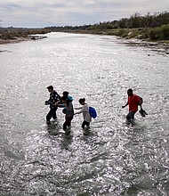 An immigrant family crosses to the American side of the Rio Grande on December 19, in Eagle Pass, Texas. A major surge of migrants crossing the U.S.-Mexico border to seek political asylum has overwhelmed U.S. border authorities in recent weeks.
Mandatory Credit:	John Moore/Getty Images
