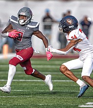 Virginia Union University’s running back Jada Byers dodges Virginia State University’s Quedrion Miles on Nov. 4. VUU, under the watchful eyes of Coach Alvin Parker and staff, won 30-20.