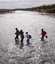 An immigrant family crosses to the American side of the Rio Grande on December 19, in Eagle Pass, Texas. A major surge of migrants crossing the U.S.-Mexico border to seek political asylum has overwhelmed U.S. border authorities in recent weeks.
Mandatory Credit:	John Moore/Getty Images