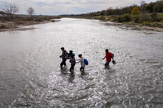 An immigrant family crosses to the American side of the Rio Grande on December 19, in Eagle Pass, Texas. A major surge of migrants crossing the U.S.-Mexico border to seek political asylum has overwhelmed U.S. border authorities in recent weeks.
Mandatory Credit:	John Moore/Getty Images