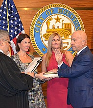 John Whitmire being sworn in as the City of Houston's 63rd mayor on January 1, 2024, by Harris County Justice of the Peace Victor Trevino, III, with daughters, Whitney Whitmire Jenkins and Sarah Whitmire.